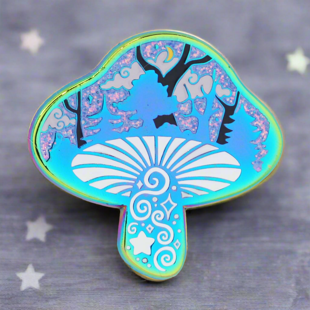 An enamel pin with a silhouette of a mushroom containing a miniature scene with trees and glitter, in rainbow colors.