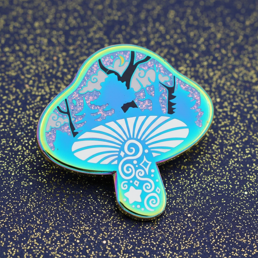 An enamel pin with a silhouette of a mushroom containing a miniature scene with trees and glitter, in rainbow colors.