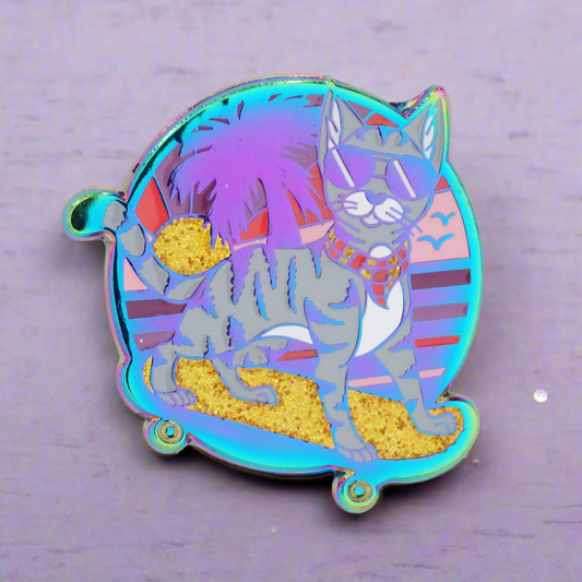 A colorful enamel pin featuring an illustration of a cat with rainbow metal accents and glitter, on a two-pin post system.