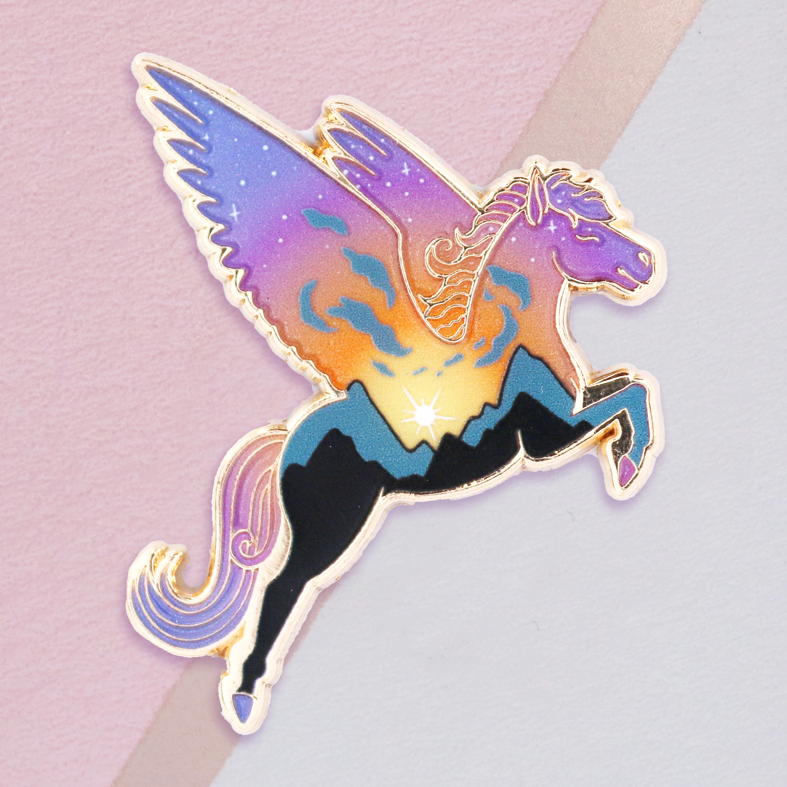A gold metal enamel pin featuring a mythological creature, Pegasus, with a gradient sky background and clear pearl fill.