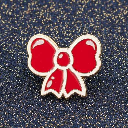 Red bow-shaped pin on a pink and white background