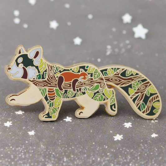A gold metal hard enamel pin shaped like a red panda with a forest and animal pattern.